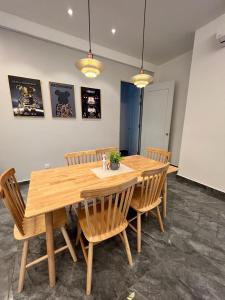 a wooden table and chairs in a room at Inn Homestay 2nd Floor Jasmine and Lavender unit in Teluk Intan