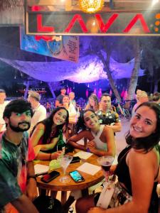 a group of people sitting at a table at a party at Gili Beach Bum Hostel in Gili Trawangan