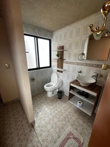 a bathroom with a toilet and a sink at CASA MARIN Pochote in Oaxaca City