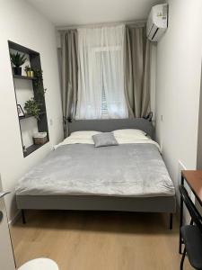 a bedroom with a large bed with a window at DOLLY APARTMENT in Zagreb