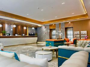 a lobby of a hotel with couches and a bar at Slowcom┃Yuebei Hotel （Guangzhou Provincial Government) in Guangzhou