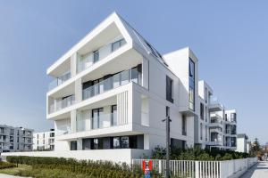 an image of a white apartment building at Lion Apartments - New Helsinki Okrzei 19 in Sopot