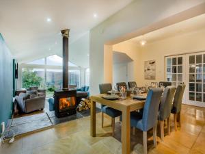 a dining room with a table and a fireplace at Ardachy in Lewiston