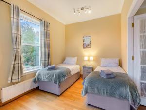 a bedroom with two beds and a window at Ardachy in Lewiston