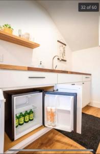 een open koelkast in een keuken met een wastafel bij inactive account in Redding