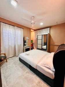 a bedroom with a large bed and a window at Te’bing Homestay in Paka