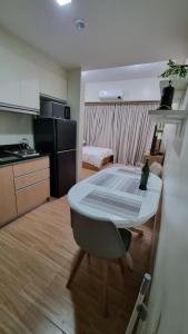 une chambre avec une table et une cuisine et une chambre avec une cuisine dans l'établissement St. Honoré & St. Dominique, à Iloilo