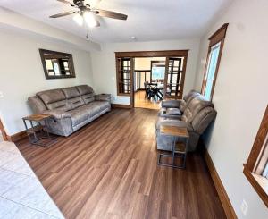 a living room with two couches and a ceiling fan at Spacious Home Lake Minnetonka Downtown Excelsior in Excelsior