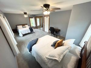 a bedroom with a bed and a ceiling fan at Spacious Home Lake Minnetonka Downtown Excelsior in Excelsior
