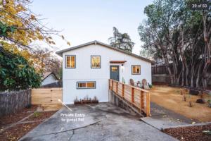 a white house with a wooden fence at Newly renovated, modern and cosy one bedroom condo with full kitchen and lounge in Redding