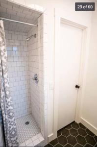 a bathroom with a shower with a glass door at Newly renovated, modern and cosy one bedroom condo with full kitchen and lounge in Redding
