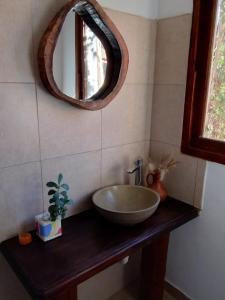 a bathroom with a bowl sink and a mirror at Luna Jatun in Purmamarca