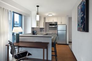 a kitchen with a desk and a refrigerator at Residence Inn by Marriott Boston Back Bay/Fenway in Boston