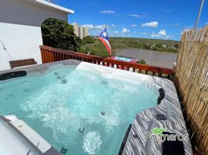 a hot tub on the balcony of a house at Palmeras Beach Apartments - Playa Santa in Guanica