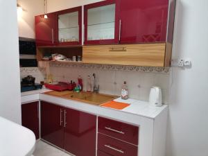 a kitchen with red cabinets and a sink at Villa Turquoise in Calodyne