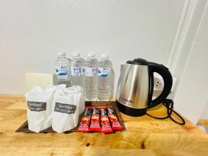 a table with bottles of water and a tea kettle at Lungwang Guest House in Ban Rak Thai