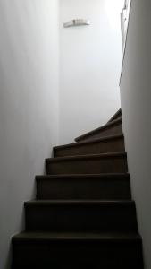 una escalera con escalones negros en una habitación blanca en Safranier Townhouse en Antibes