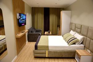 a hotel room with a bed and a tv at Edwin Plus Hotel in Istanbul