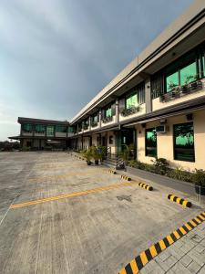 an empty parking lot in front of a building at Dancels Inn in Ormoc