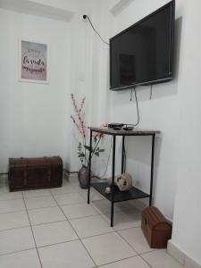 a living room with a television on a wall at Patagonia Relax in Comodoro Rivadavia