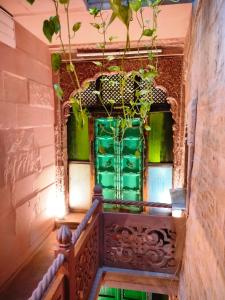 a staircase in a building with green glass doors at Casa De Jodhpur in Jodhpur