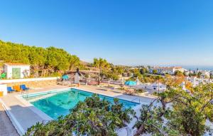 an outdoor swimming pool with a view of the ocean at 4 bedrooms villa with sea view private pool and furnished garden at Mijas 6 km away from the beach in Mijas