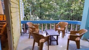 a patio with chairs and a table on a balcony at Anna homestay in Dirang Dzong