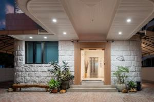 a lobby of a house with a bench and plants at Codrington House - Boutique Apartments in George Town