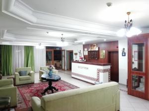 a living room with a couch and a fireplace at Hotel Ave Maria in Selçuk