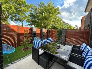 a patio with a table and chairs and a fence at Stunning Dickson Luxe 3BR 2Bath Double Garage WiFi Brand New Home in Canberra