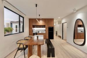a kitchen and dining room with a table and chairs at Codrington House - Boutique Apartments in George Town