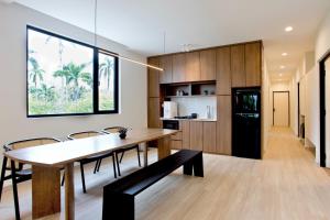 a kitchen and dining room with a table and chairs at Codrington House - Boutique Apartments in George Town