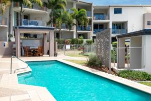 a swimming pool in front of a apartment building at Caloundra Poolside Paradise in Caloundra