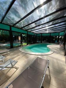 a swimming pool in a building with a roof at B&B Etna Country in Tremestieri Etneo