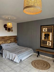 a bedroom with a bed and a table and a lamp at Studio 14 proche GRR2 97400 in Saint-Denis