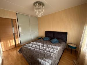 a bedroom with a bed and a chandelier at Liikuri 8a Apartment in Tallinn