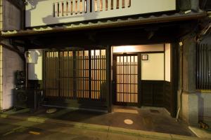 an entrance to a building with a gate at Shirafuji-an Modern Private Machiya in Central Kyoto in Kyoto +33 photos