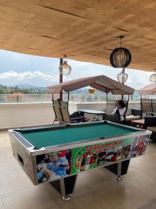 a pool table in a room with a table at Kantree House - Safari Suites in Kampala