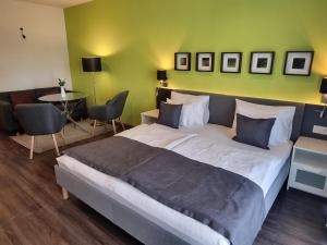 a bedroom with a large bed and a table and chairs at RiverCity Apartments in Budapest