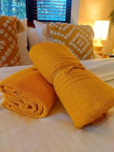 a yellow towel sitting on top of a bed at Perfect and modern Studio, Broadway-Chippendale in Sydney