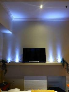 a flat screen tv sitting on a shelf in a room at Perfect and modern Studio, Broadway-Chippendale in Sydney