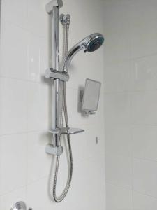 a shower with a shower head in a bathroom at Perfect and modern Studio, Broadway-Chippendale in Sydney +21 photos