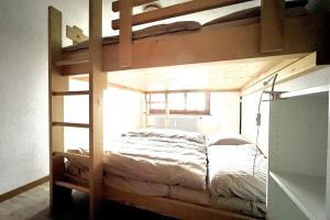 a bedroom with a bunk bed with a ladder at "Petit flocon" Appartement au centre de Verbier in Verbier