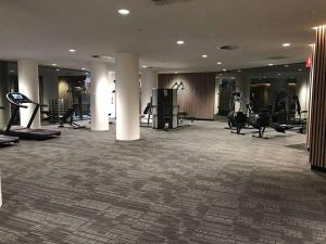 a gym with treadmills and exercise equipment in a building at Relax and Unwind by the Dock -Car park included- in Melbourne