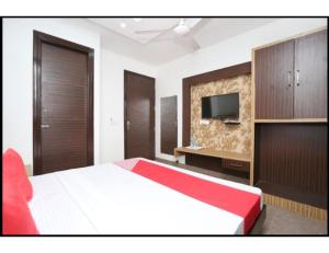 a bedroom with a large bed and a television at Hotel Royal, Amritsar in Amritsar