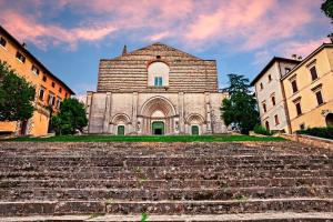 a large building with stairs in front of it at Casa vacanze Iris in Todi