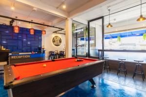 a pool table in a room with a bar at Marco Polo Phuket Poshtel & Bistro in Phuket