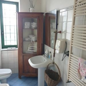 a bathroom with a sink and a toilet and a mirror at Baia dei Cesari in Bacoli