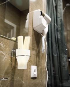 telefono appeso a un muro in bagno di Hotel "CONTINENT" halal a Karagandy