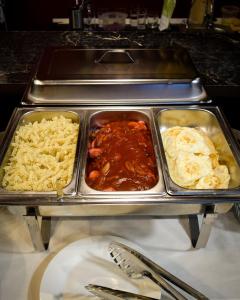 Hotel "CONTINENT" halal في كاراغاندي: بوفيه مع وجود الطعام في الصواني على طاولة